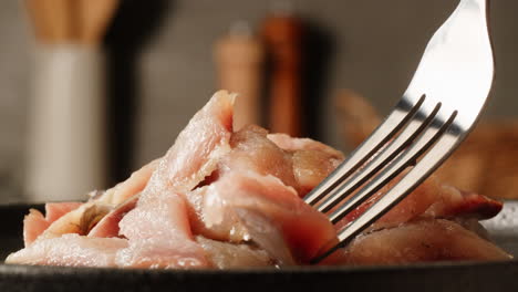 sliced fish on a plate with fork