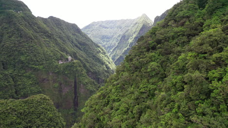 aerial flight over the dramatic rugged mountains on reunion island with the takamaka waterfalls and marsouins river below