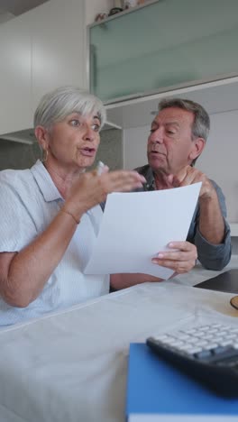 Couple discussing documents in the kitchen
