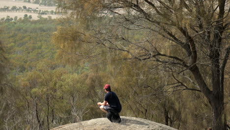 Man-looking-out-from-the-You-Yangs-National-Park,-Victoria-Australia