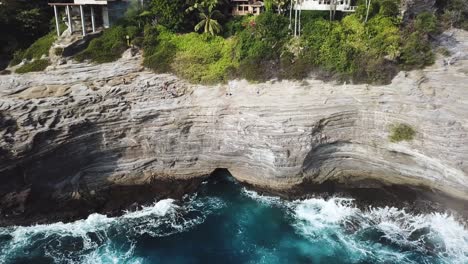 drone shot of the beautiful and dangerous cliffs called spitting caves located near honolulu, hawaii