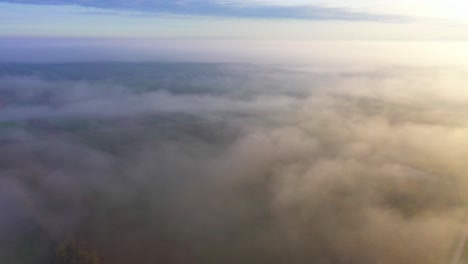 Foggy-Clouds-Engulfing-Countryside-Landscape-During-Autumn-In-Sunrise