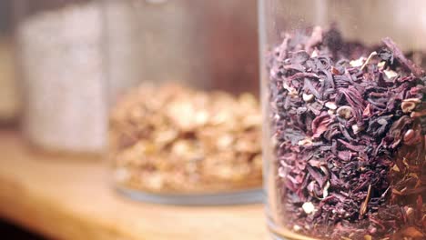 close-up of dried hibiscus tea in a glass jar