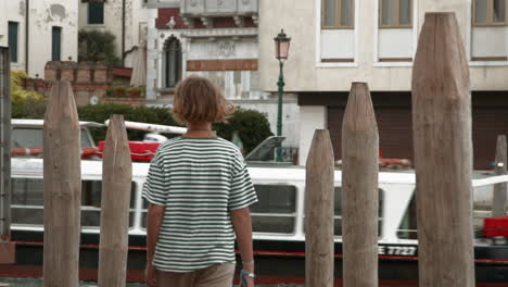 teenager capturing venetian canal view