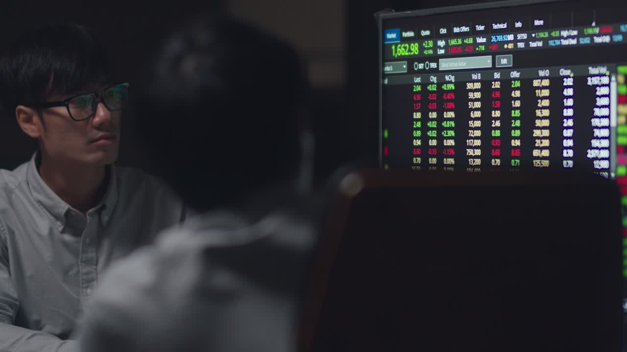 Asia businessmen meeting brainstorming ideas conducting business presentation project colleagues working together plan success strategy enjoy teamwork in night office.