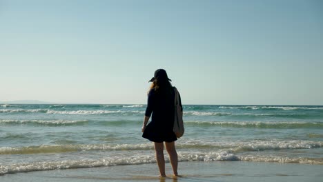 female-young-asian-tourist-walking-on-beach-on-stradbroke-island,-Brisbane,-Australia