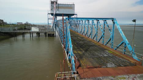 Full-view-of-derelict-bridge-on-abandoned-dockland-at-Fleetwood-Docks-Lancashire-UK