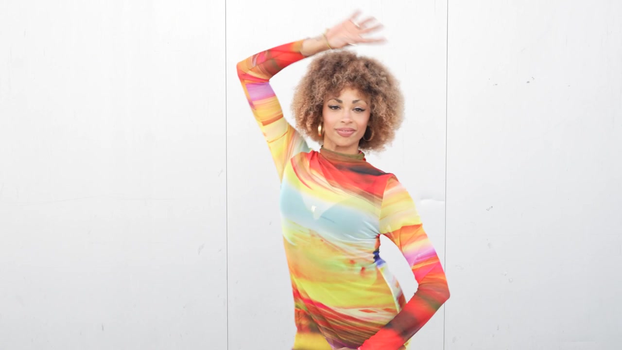 Vibrant fashion a young woman dressed in a colorful dress posed against a minimalist background