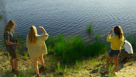 High-angle-view-of-friends-having-fun-near-lakeside-4k