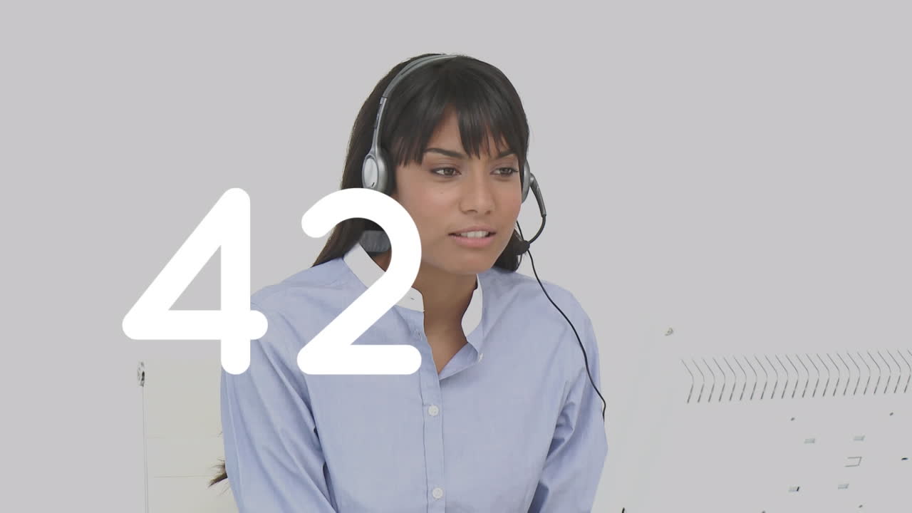 Changing numbers against female customer care executive talking on phone headset at office
