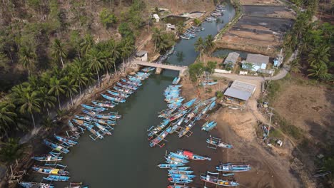 Aerial-view-of-fishing-boats-lining-the-Cokel-River-in-Pacitan,-Indonesia