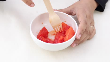 spoon pick water melon on table ,