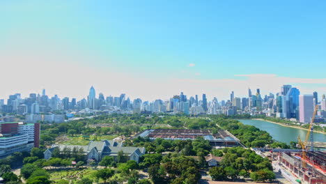 bangkok thailand time lapse, sunny day on skyscrapers, benjakitti park lake and construction site