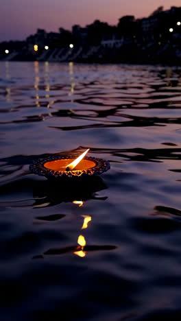 floating diya on the ganges river at sunset