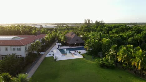 Aerial-view-of-a-nice-property-in-southern-florida,-pool-and-a-tiki-tropical-vibes-travel-resort