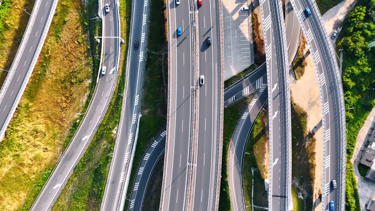 Cars run by the roads built close to each other on diverse levels. Conjunction in the rural area of Slovakia. Top view.