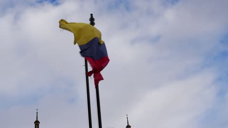 Die-Nationalflagge-Kolumbiens-Weht-An-Einem-Windigen-Tag-Auf-Der-Stange,-Aus-Nächster-Nähe