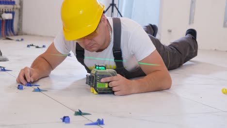 a professional tiler works in the bathroom of a modern house