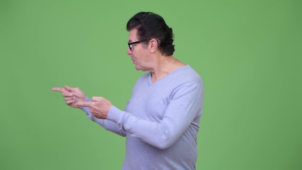 Senior handsome man talking to camera