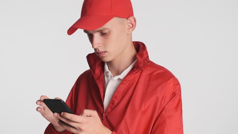 delivery guy in red uniform using phone