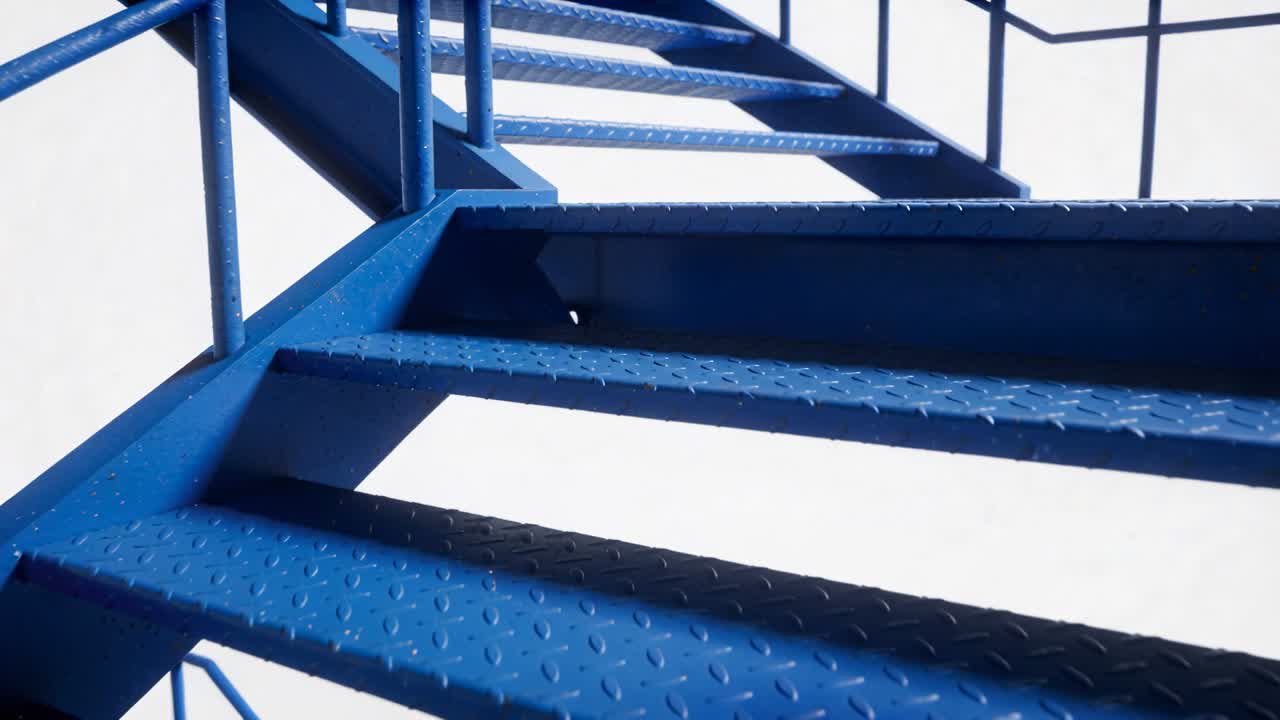 Moving camera operator-triggered traveling upward along outdoor blue metal stairs revealing welds