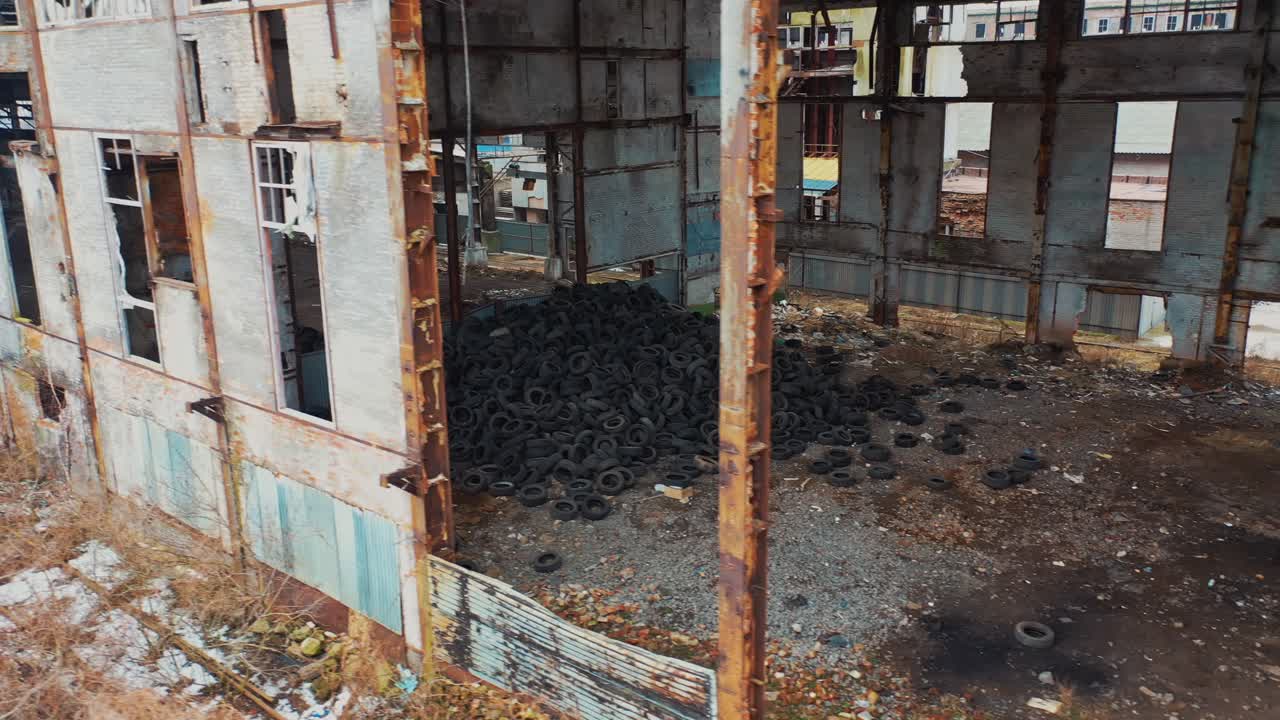 Old used tires in abandoned factory. Aerial view of an abandoned industrial plant
