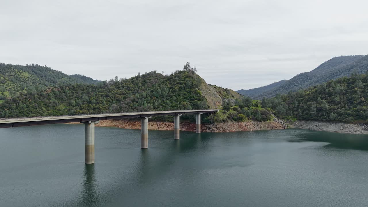 Flying overhead, a drone captures the Don Pedro Reservoir Bridge stretching across the vast lake. Shot on a DJI Air 3S.