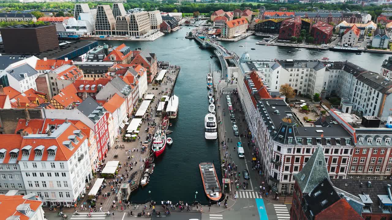 Flying above Nyhavn canal with colorful building rooftops, Copenhagen