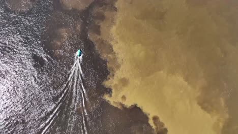 boat sailing at meeting of the waters tourism landmark at manaus amazonas brazil