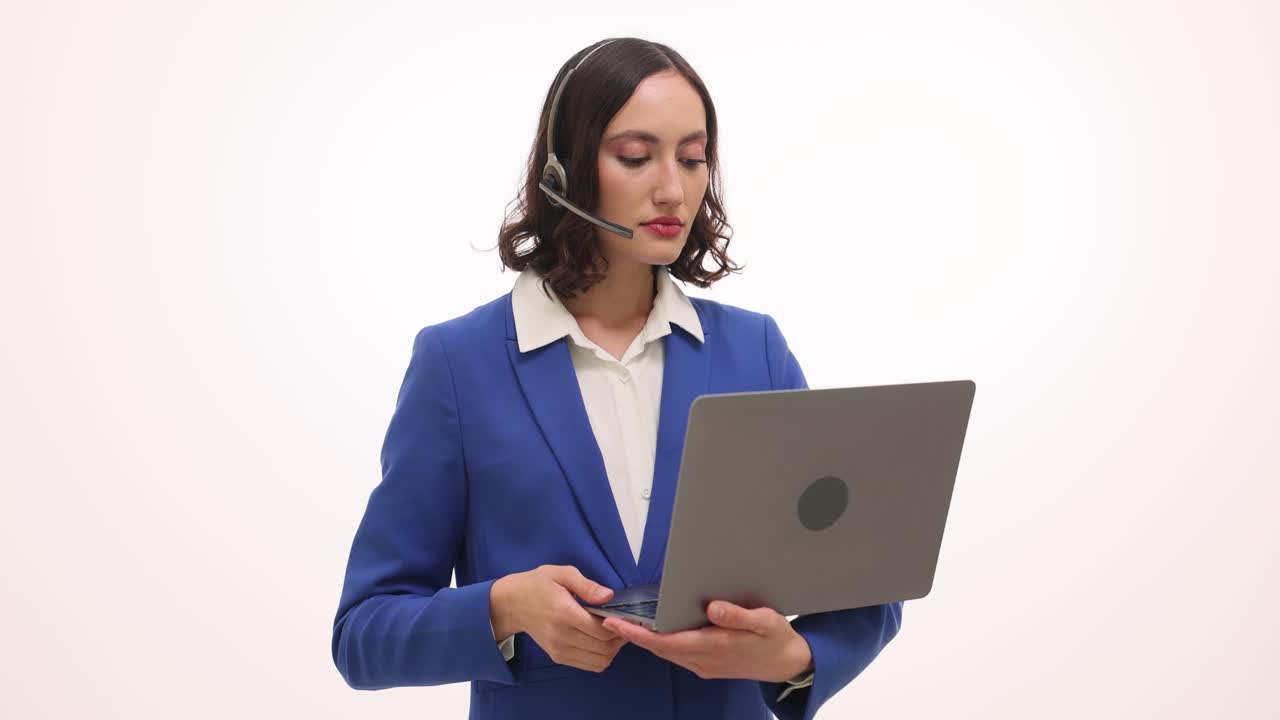 Professional Woman in Headset Using Laptop for Virtual Communication