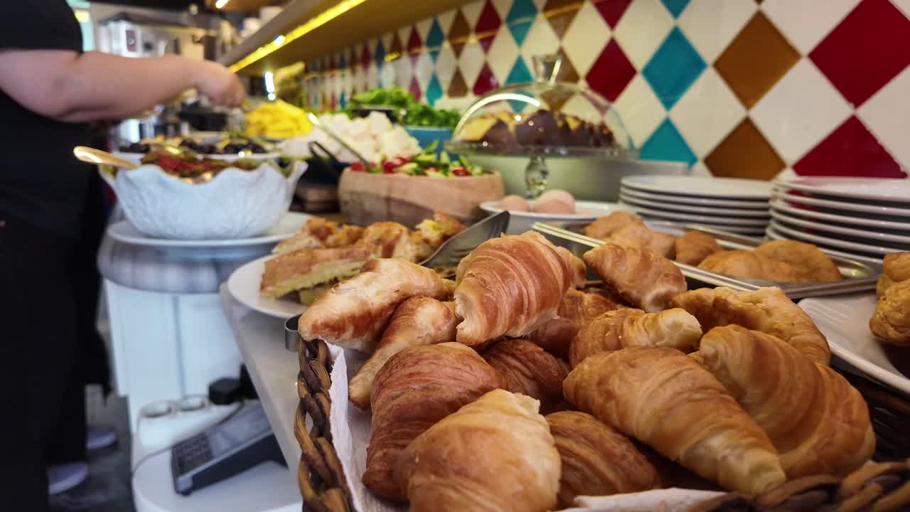Breakfast buffet with croissants and salad