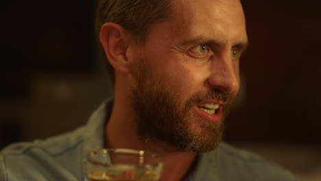 portrait of handsome man toasting during dinner