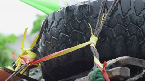 close-up of a spare tire strapped to a 4x4 getting wet in the rain