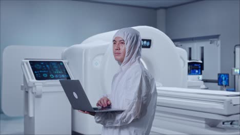 side view of asian male scientist typing on a laptop and looking around with mri machine in the hospital
