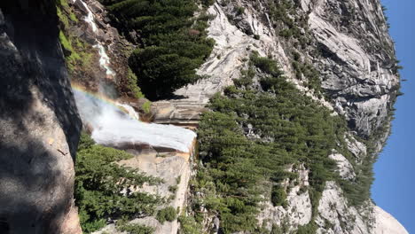 Vernal-Fall's-misty-rainbow-on-the-Merced-River-in-Yosemite-National-Park,-California---vertical