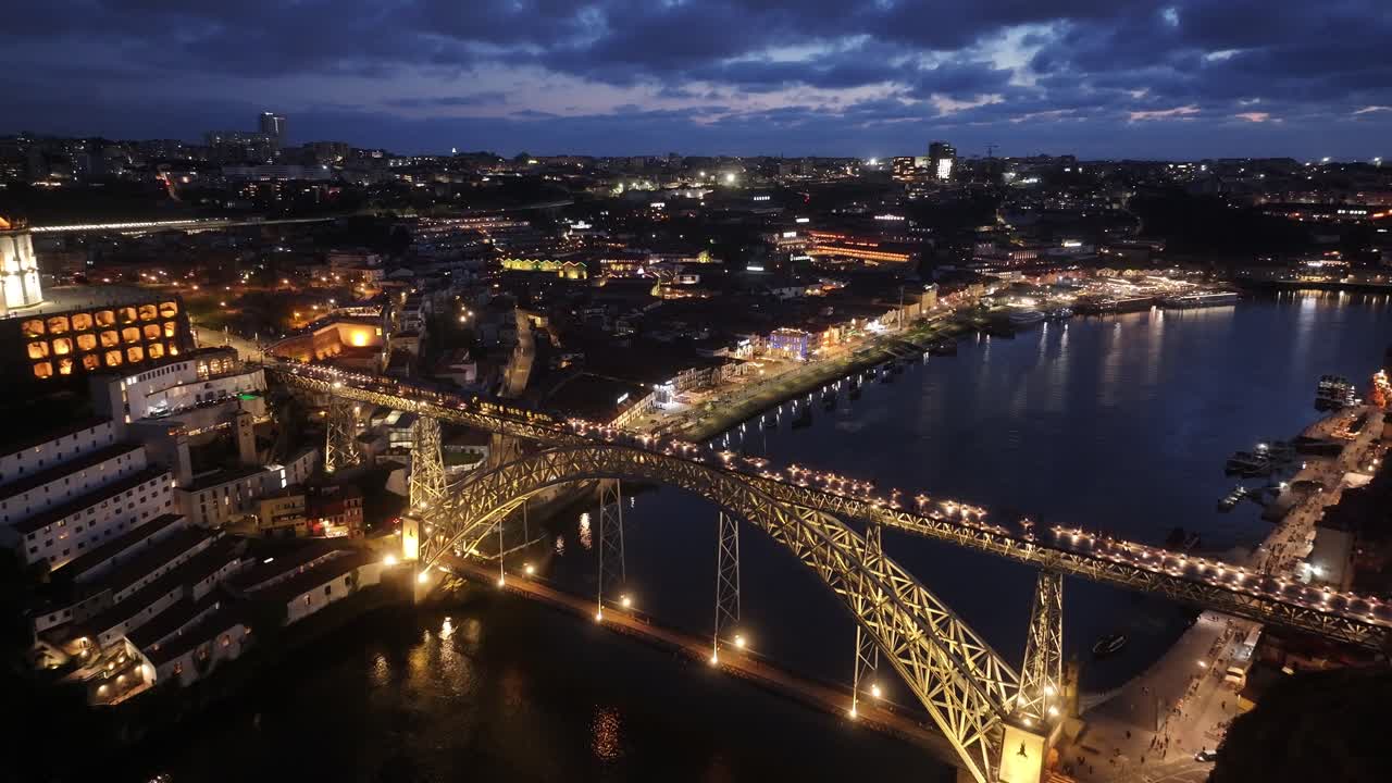 Night Dom Luis I Bridge At Porto In District Of Porto Portugal. City At Night Scene. Illuminated Bridge Landscape. Dom Luis I Bridge At District Of Porto Portugal. Railroad Transport
