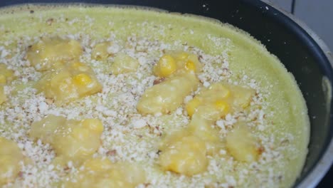 apam balik or malaysian peanut pancake turnover.  flour pancake stuffed with sugar and corn topping. cooked using the hot pan. famous street food in malaysia