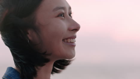 portrait of beautiful asian woman smiling enjoying carefree lifestyle exploring freedom on vacation looking happy with wind blowing hair