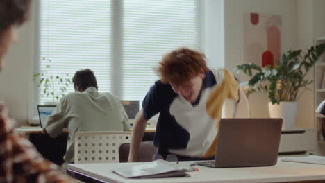 young man celebrating success with excitement during office workday