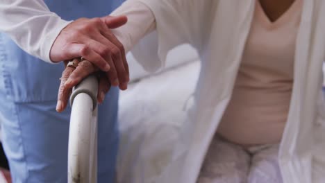 nurse helping a senior woman in a retirement home