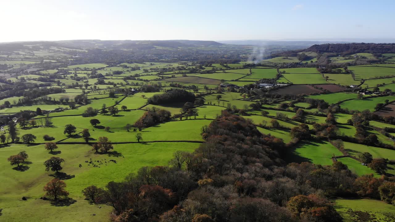 Aerial panning left shot from Dumpdon Hill looking down the Otter Valley towards Honiton and Dartmoor Devon England UK