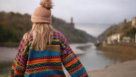 woman waling around by a river side almost slipping and falling