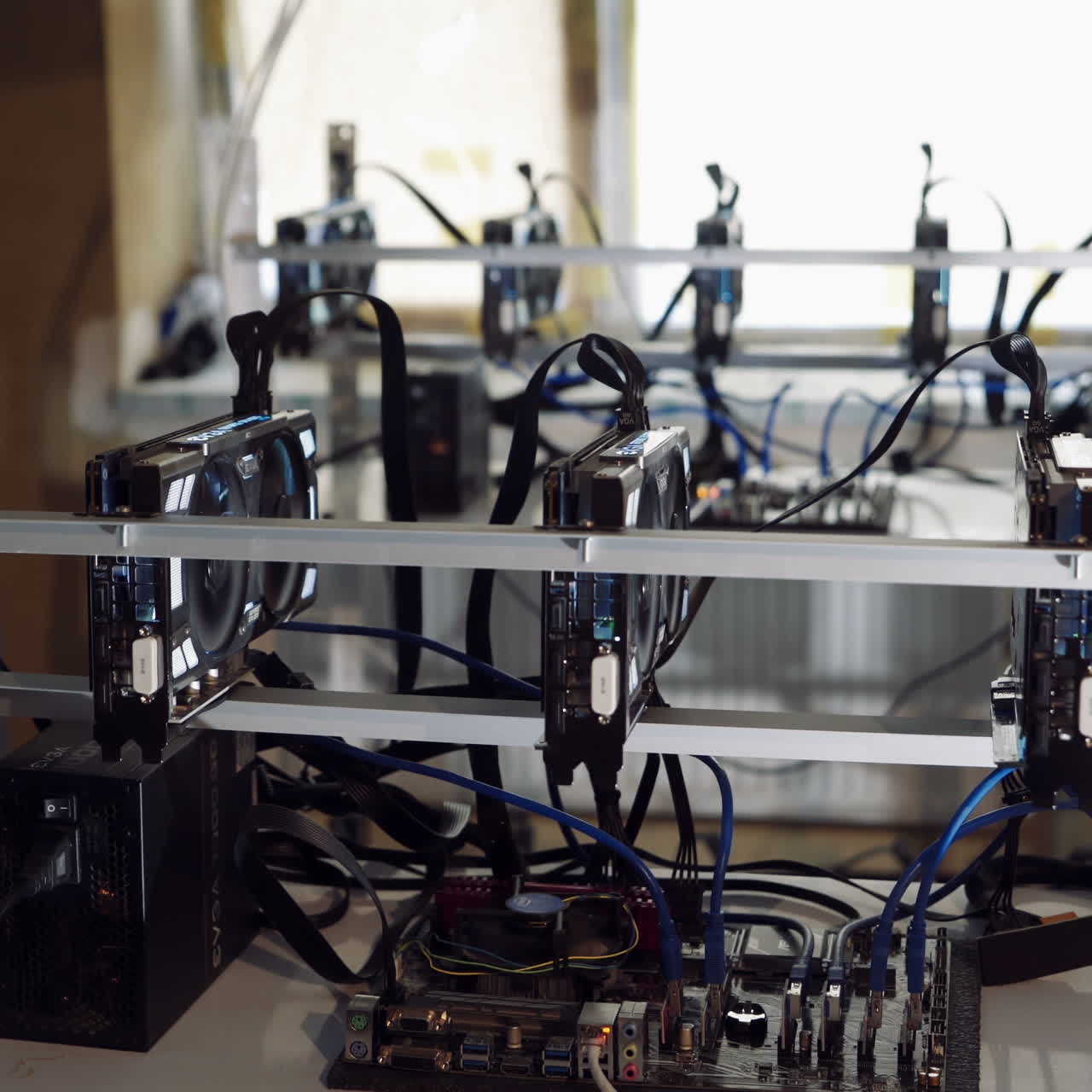 Man checks the temperature of the graphics cards on the computer. Bitcoin cryptocurrency mining farm