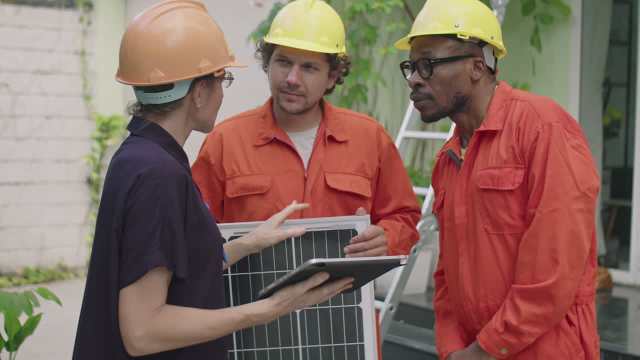 Female Engineer Instructing Multiethnic PV Installers