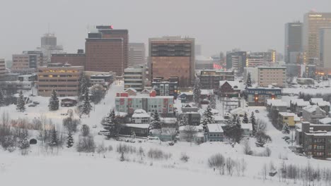 Establish-shot-city-Alaska-Anchorage-US-modern-buildings-covered-in-snow