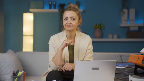 home office worker woman talking motivationally to camera.