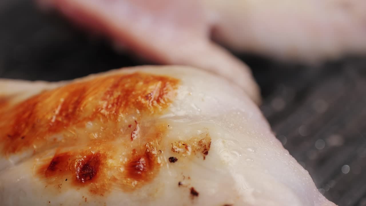 Roasted rabbit legs in a grill pan, healthy diet meat close up, chef cooking rabbit on kitchen restaurant, Black background. Top view