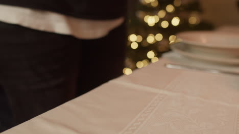 Guy-picking-up-the-bible-during-a-Christmas-dinner,-Handheld,-Closeup