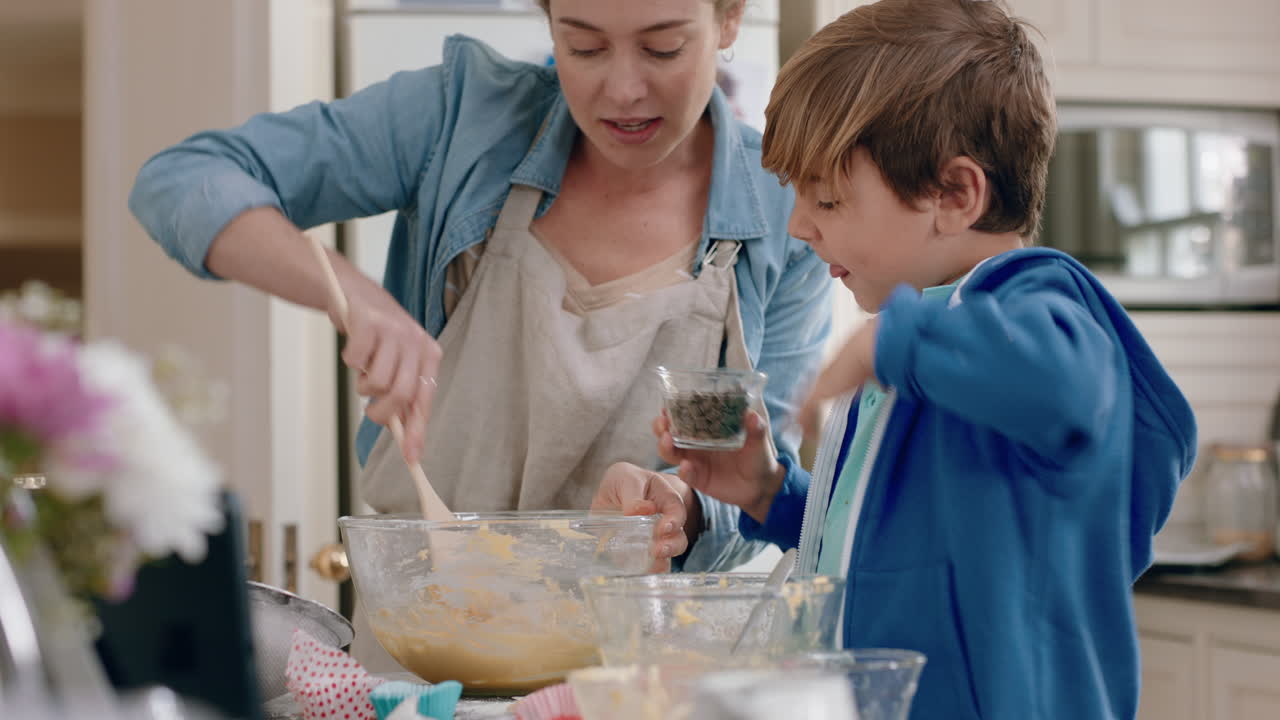 little boy helping mother bake in kitchen mixing ingredients baking cookies preparing recipe at home with mom teaching her son on weekend