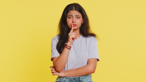 Indian-woman-presses-finger-to-lips-make-silence-gesture-sign-don't-tells-secret-stop-gossip-privacy